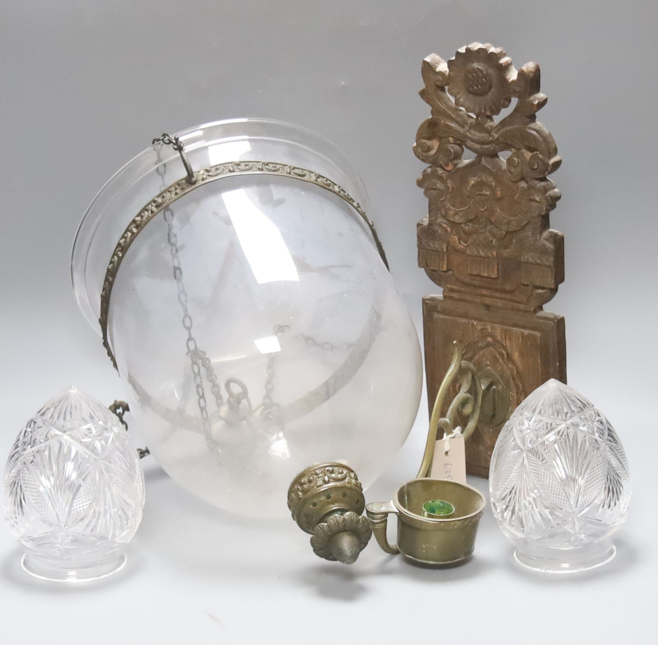 A Dutch carved wood and brass wall candle holder and a hanging glass lantern with cover